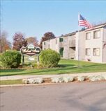 Walnut Acres Apartments exterior view with flag