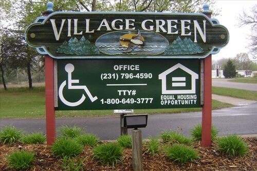 Village Green Apartments entrance hording