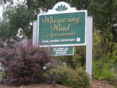 Whispering Wind Apartments entrance hording