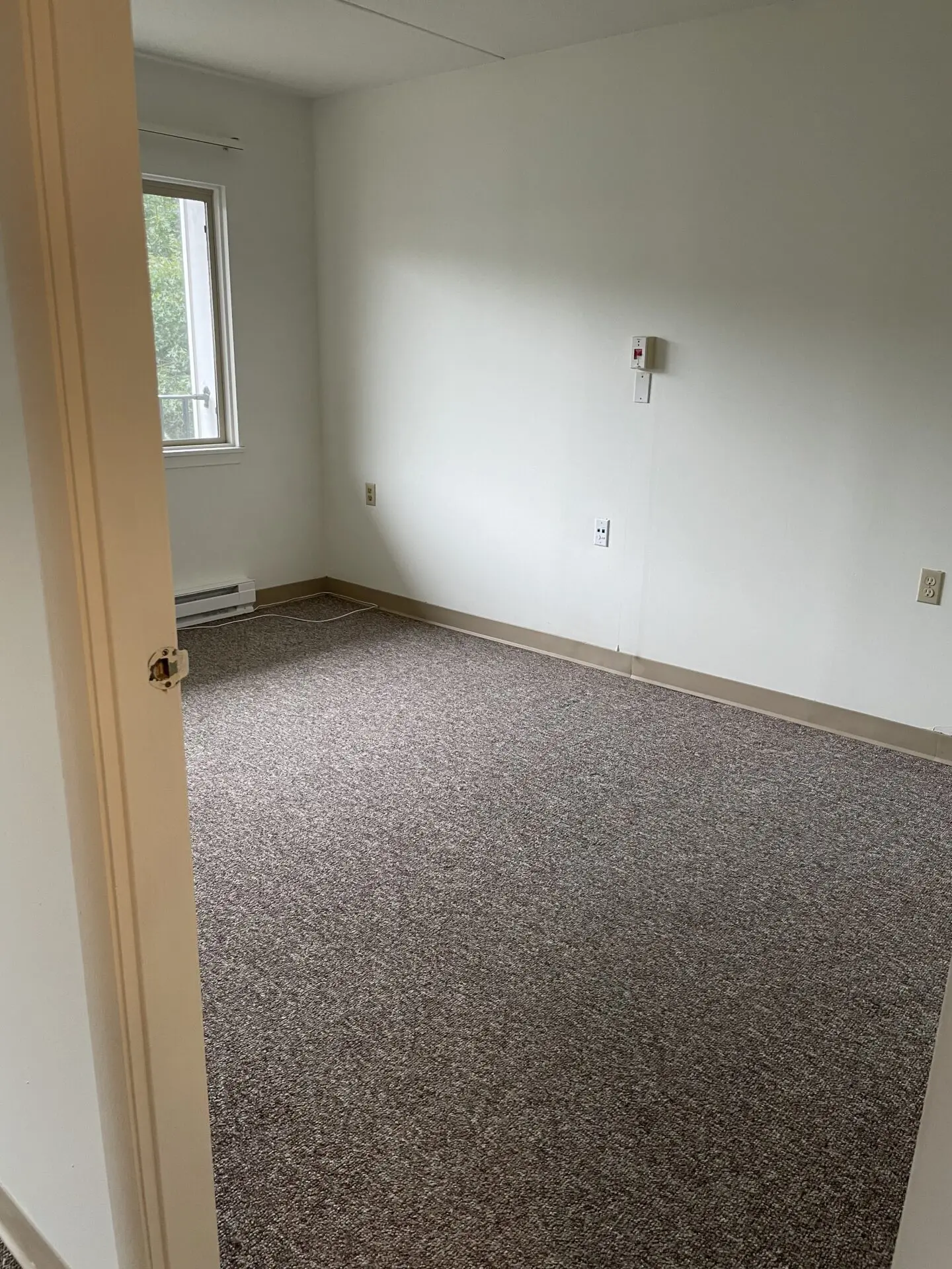 Pine Oak Apartments Interior Door and empty room