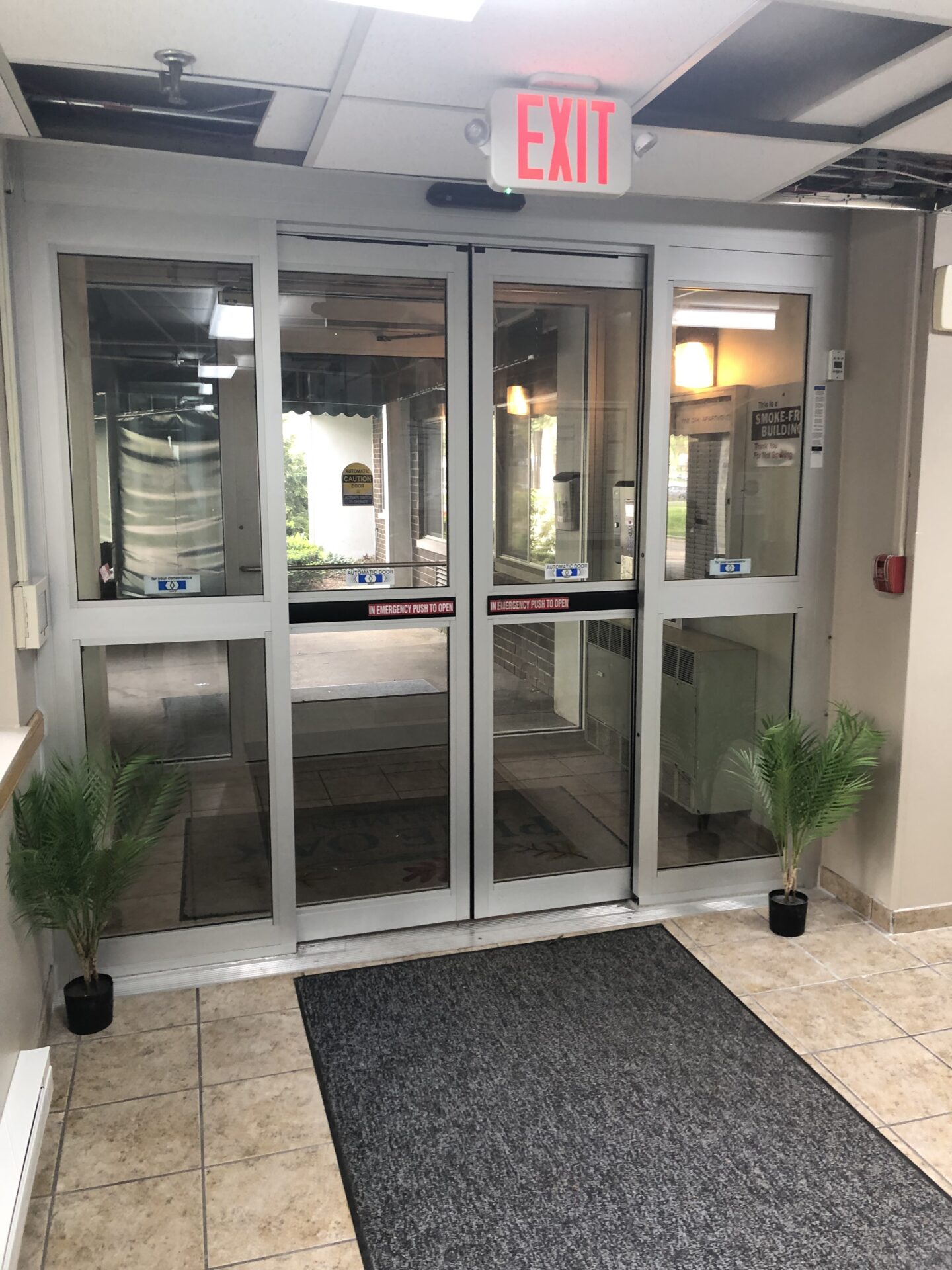 Pine Oak Apartments interior exit glass door
